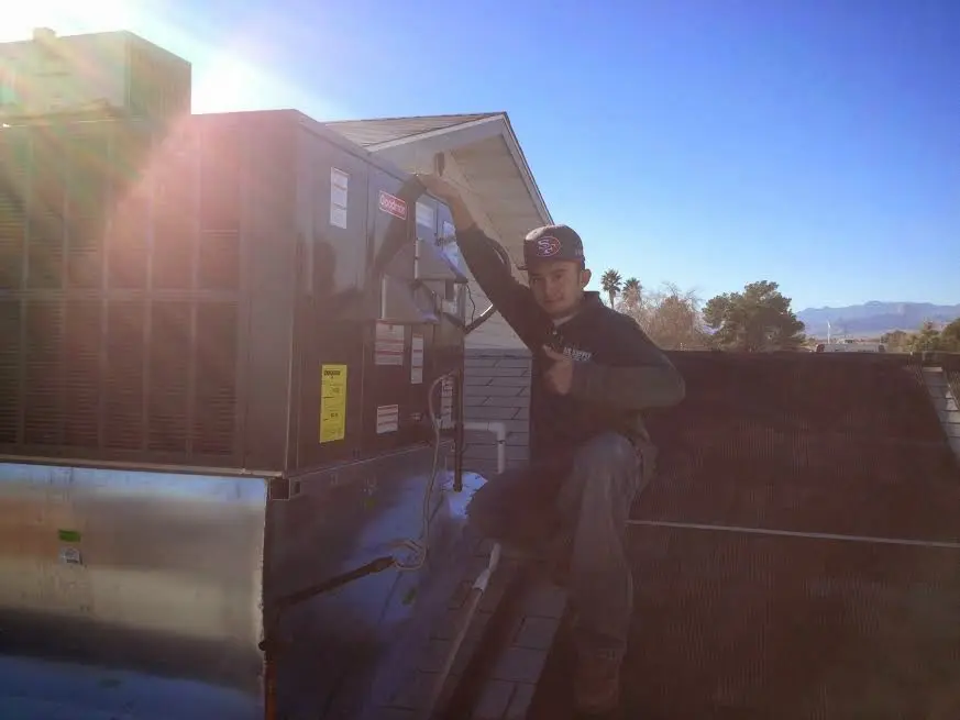 HVAC technician performing HVAC Inspection on a rooftop unit in Marlton